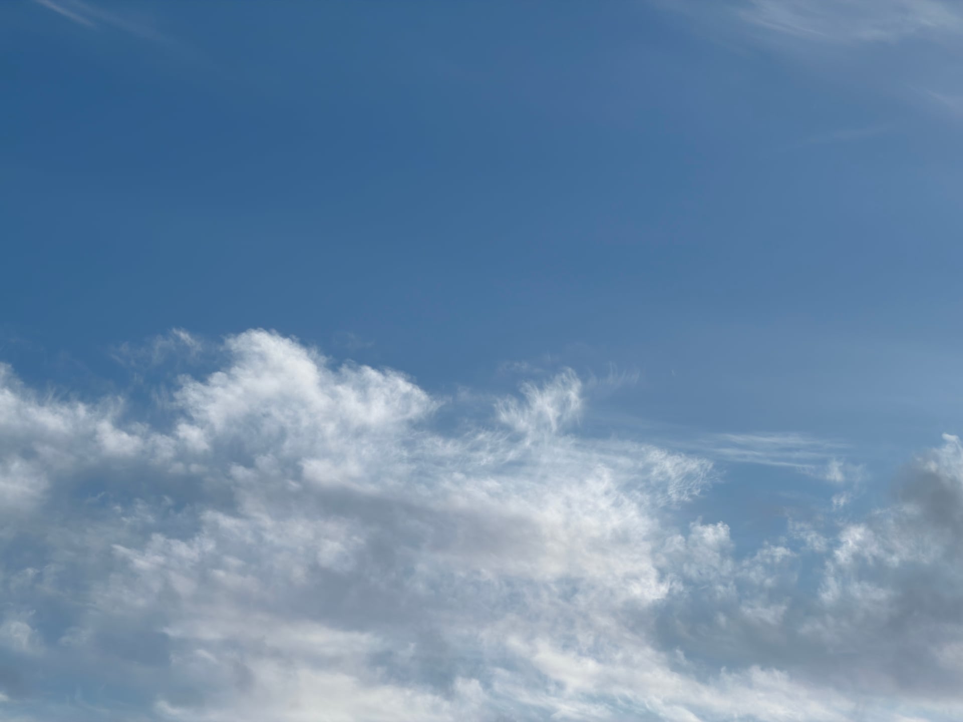 Low white clouds beneath an open blue sky.