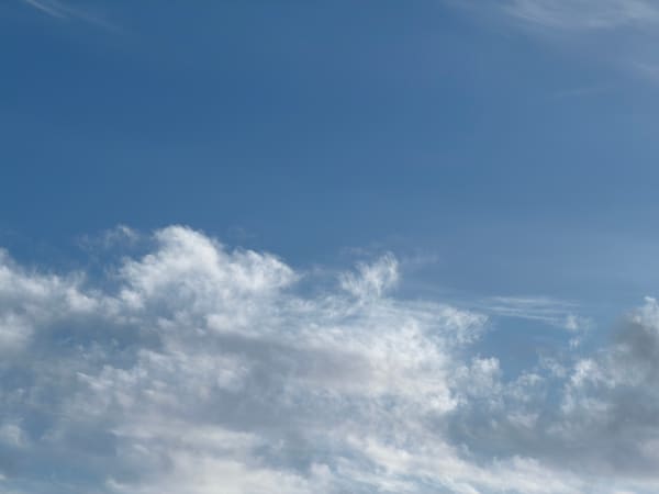 Low white clouds beneath an open blue sky.